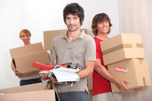 Team of house removalists handling furniture packing