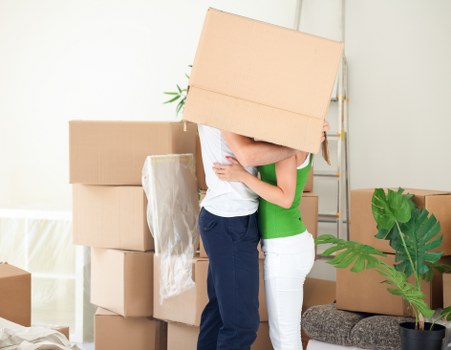 Professional movers handling office equipment